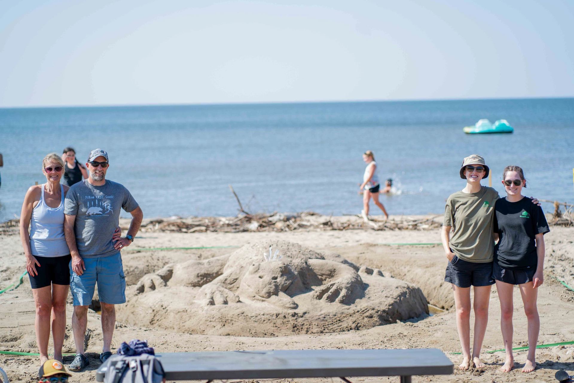 A family category team poses with their winning entry themed "Leaping Around The Lake," celebrating their success.