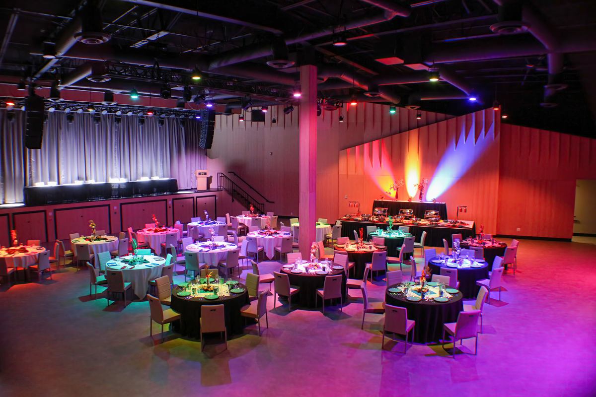 Interior of events centre set up with tables and chairs.