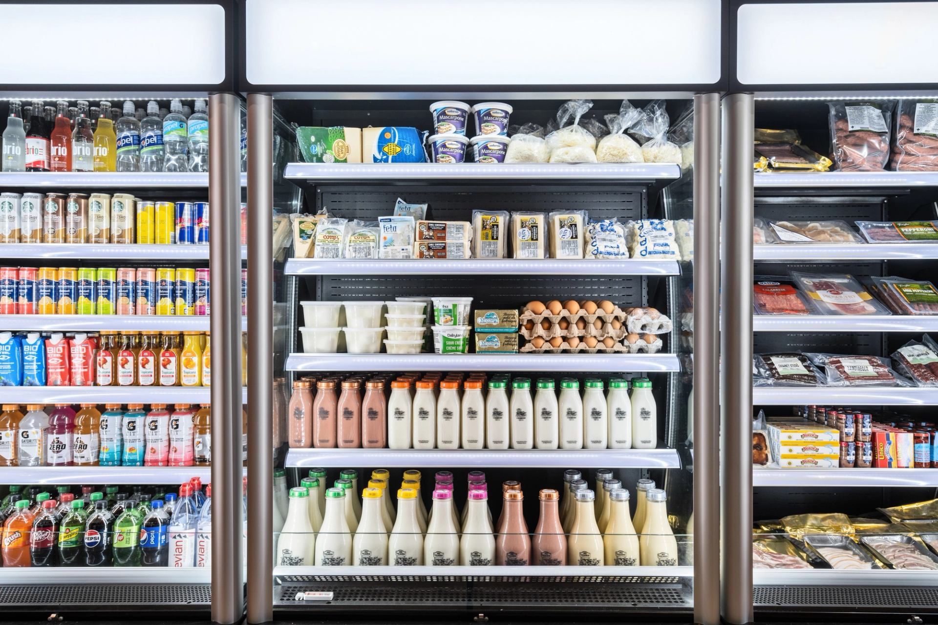 A cooler stocked with drinks, dairy, eggs, and prepackaged foods.