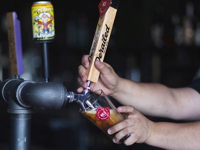 Server pouring a brew from tap