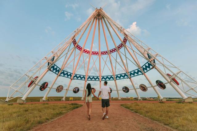 Couple visiting the worlds largest Tipi.