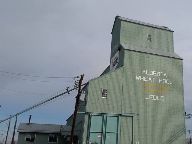 A towering green grain elevator.