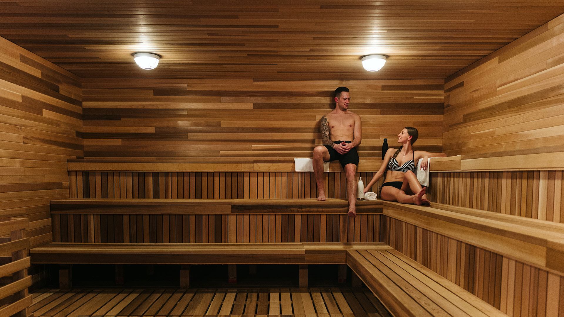Two people enjoy the sauna at Nordic Spa