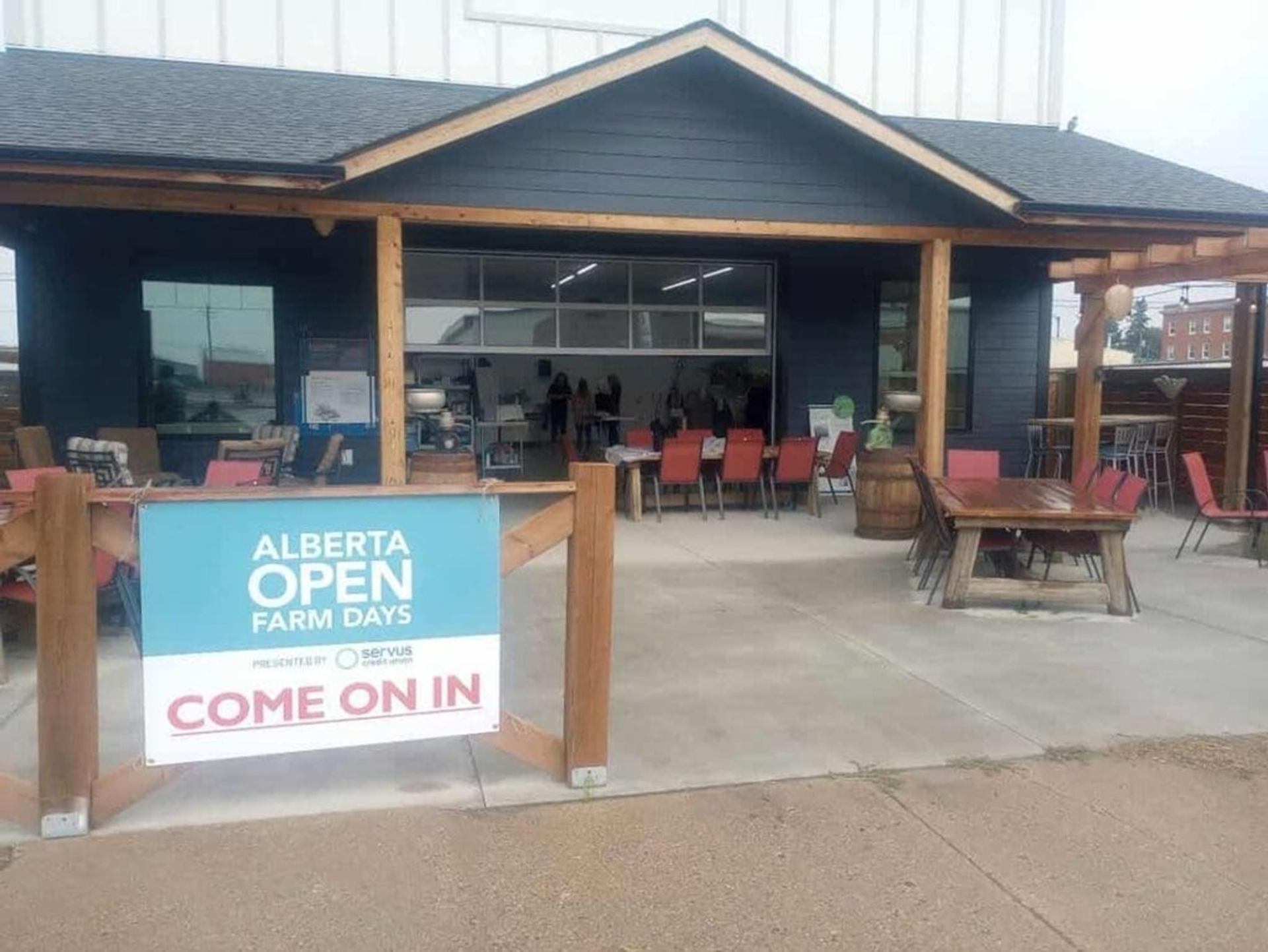 Old School Cheesery invites visitors to its outdoor patio and entrance, featuring tables and chairs 