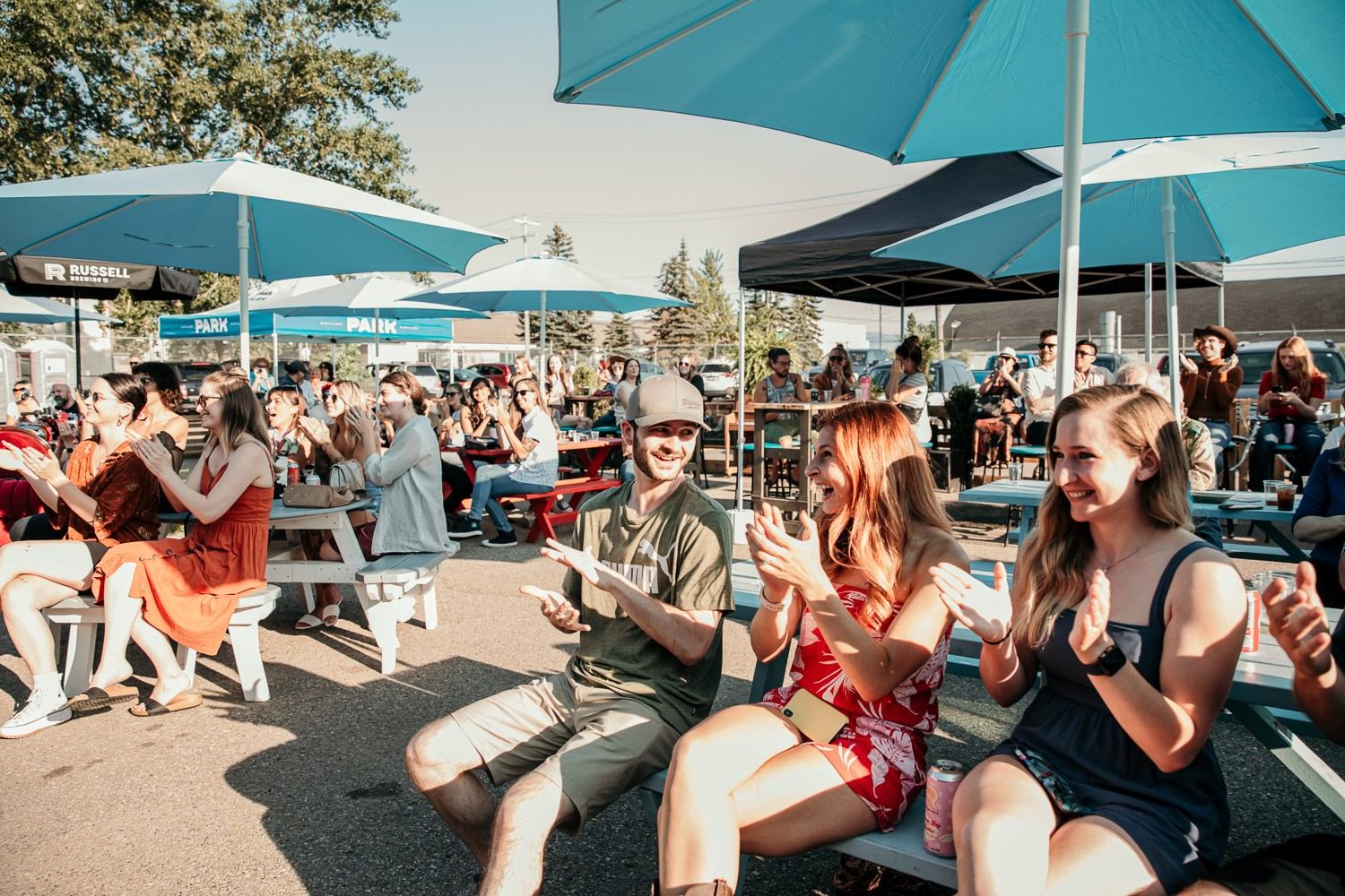 A group of people outside taking in a show.