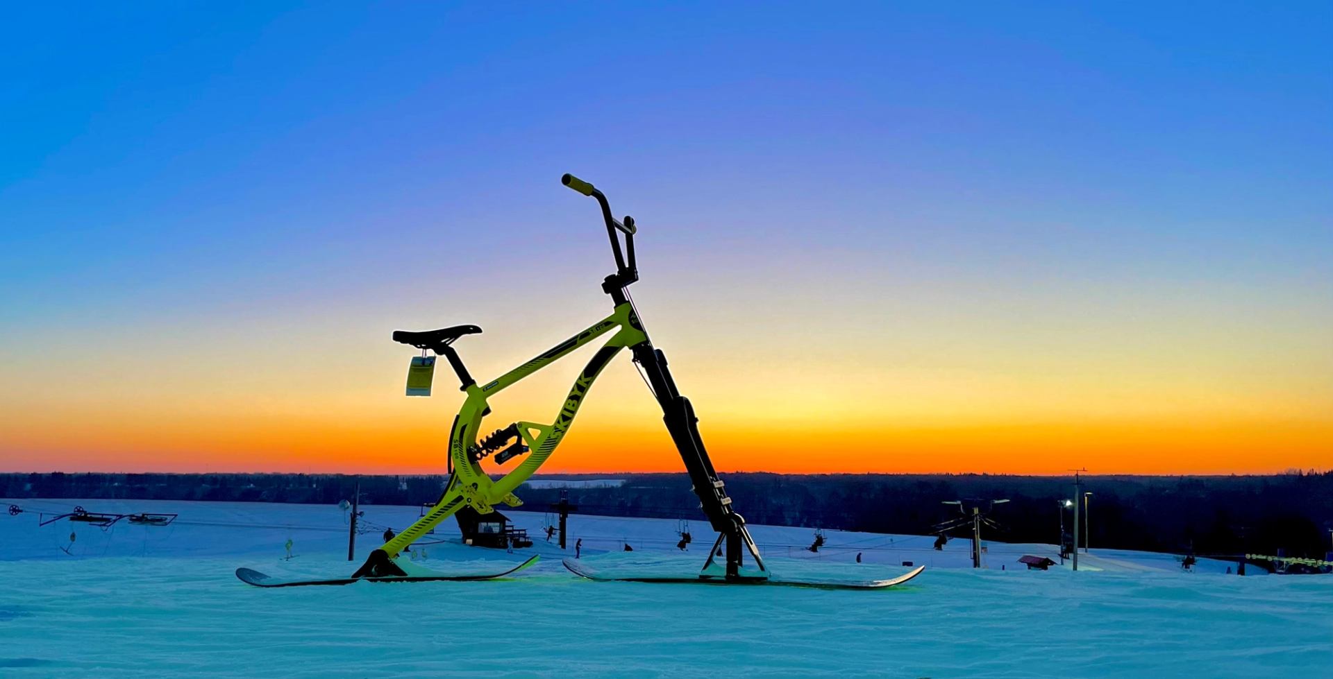 A ski bike with a sun set behind it