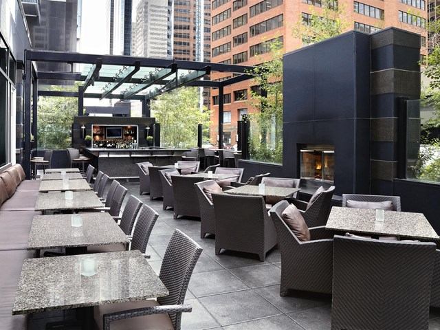 Outdoor patio with modern seating and city views.