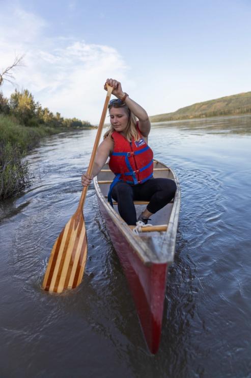 Person paddling canoe in Peace River.