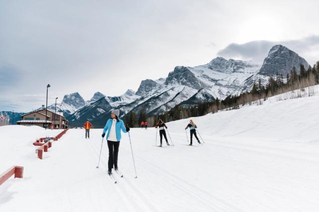 A group of visitors cross country skiing at the Canmore Nordic Centre.