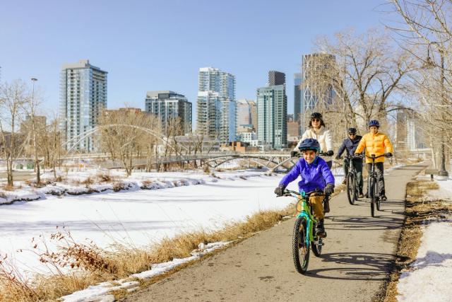 Family biking in the winter at St. Patrick's Island Park in Calgary