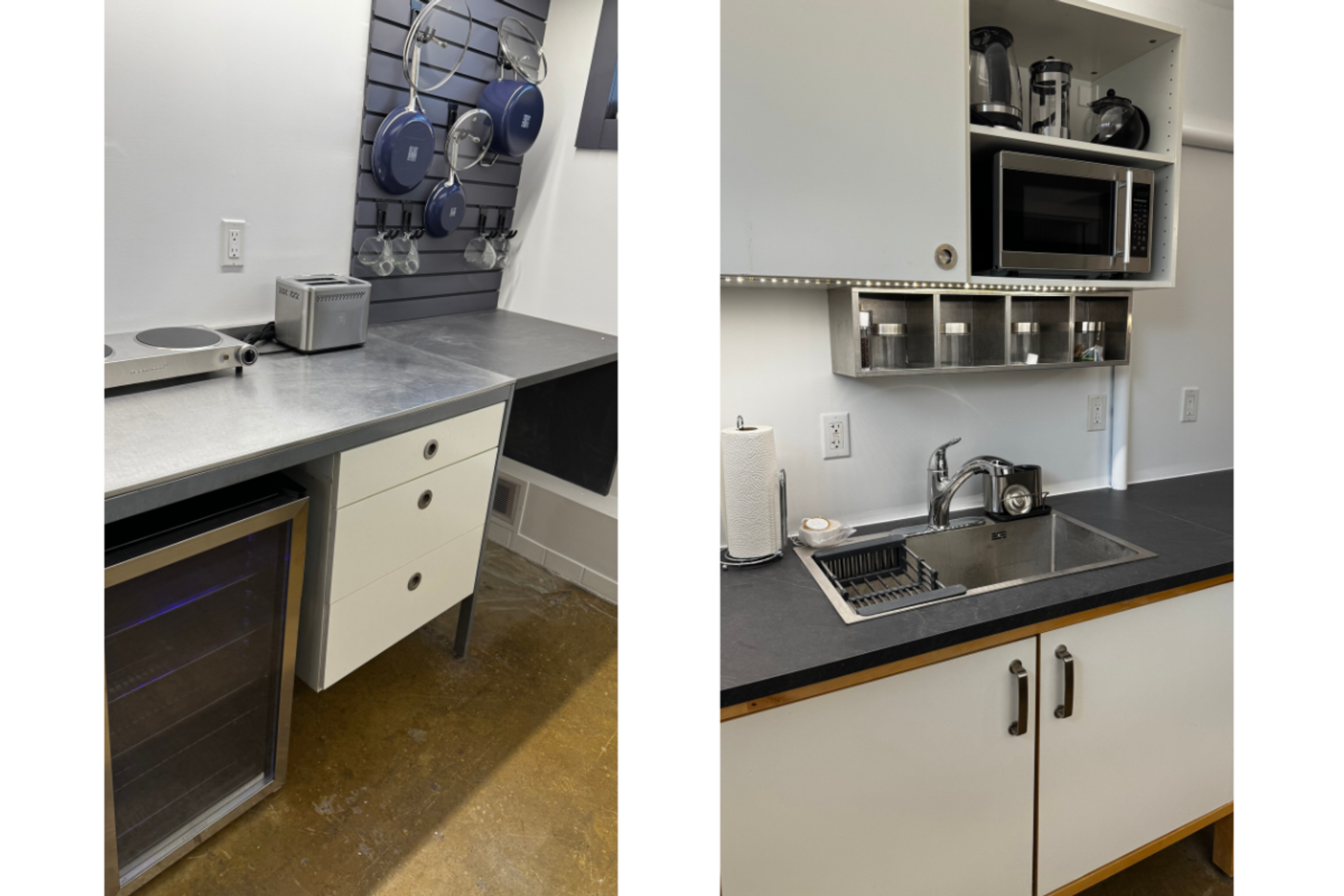 Compact kitchen with stainless counters, hanging blue pans, sink, microwave and appliances.