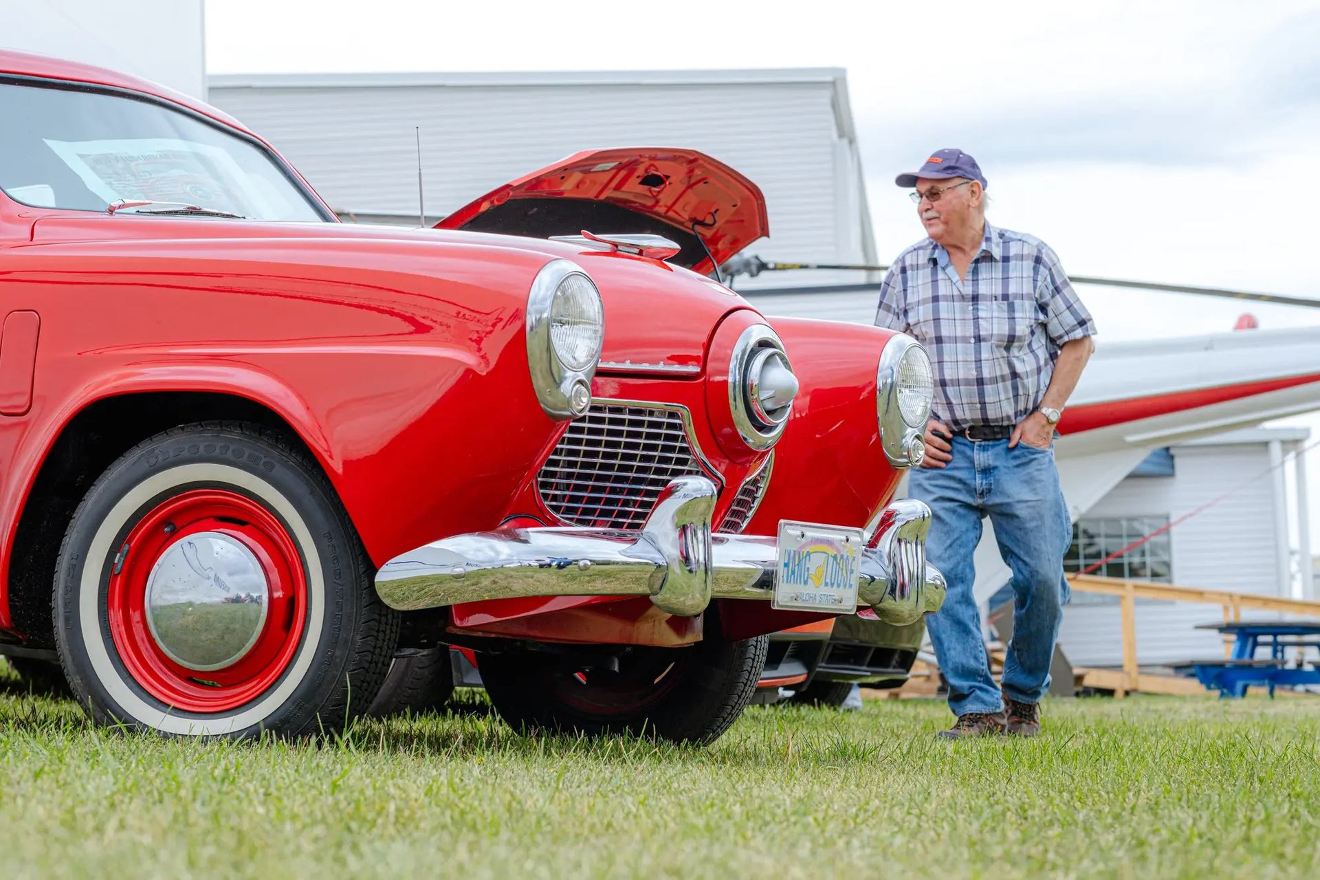 A father checking out an antique car