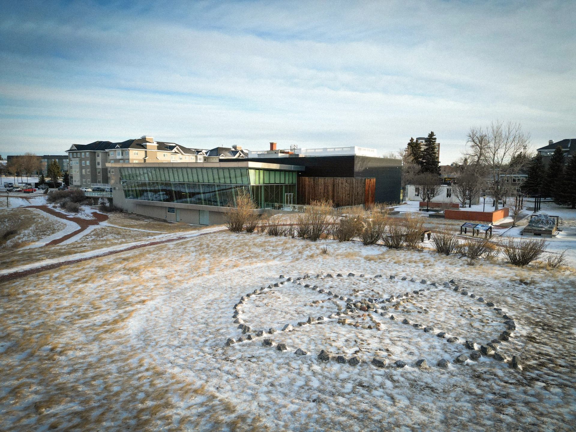 Exterior of Galt Museum with snowy grounds and stone circle design