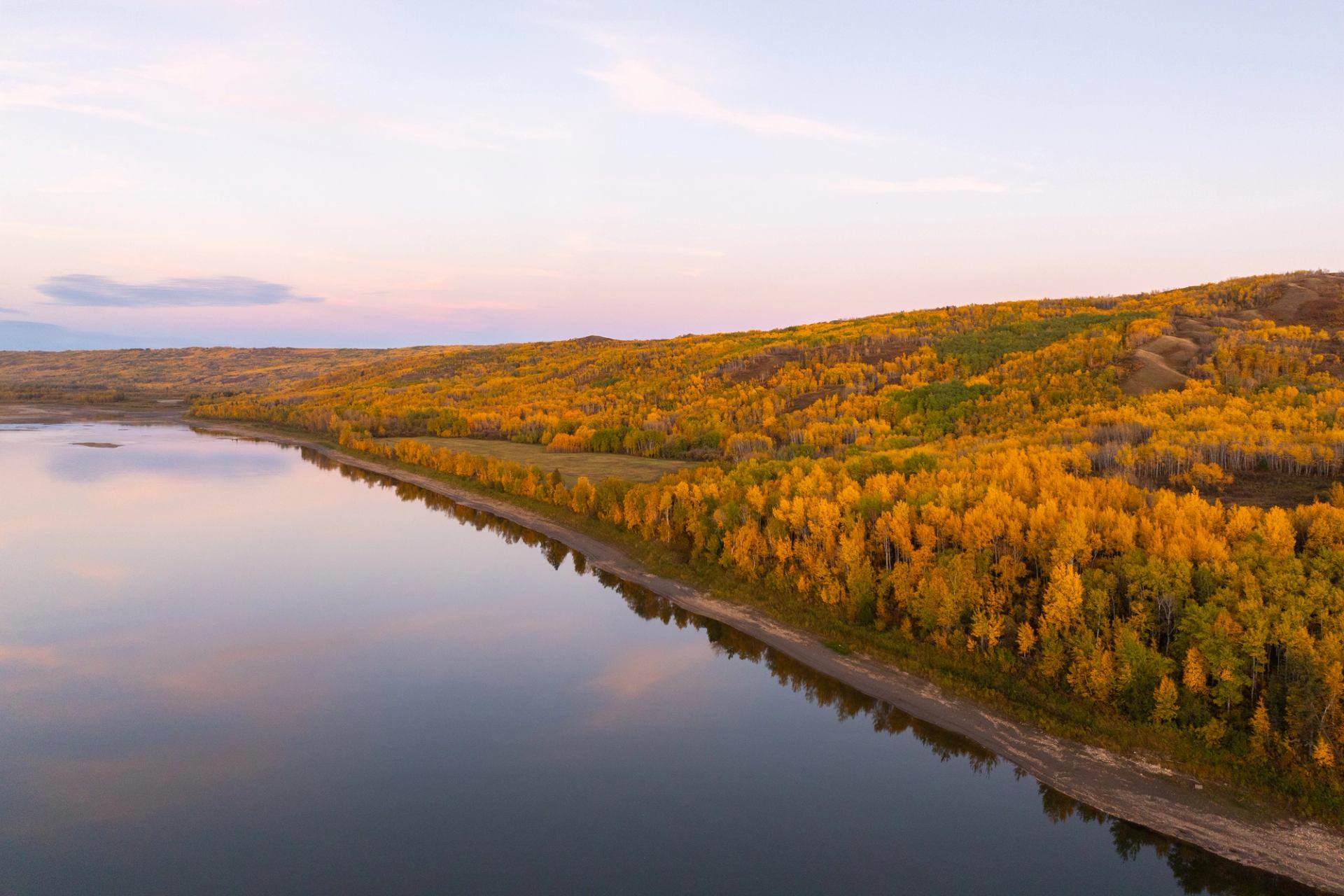 Peace River Adventures: Calm river lined with autumn trees under a soft pastel sky.