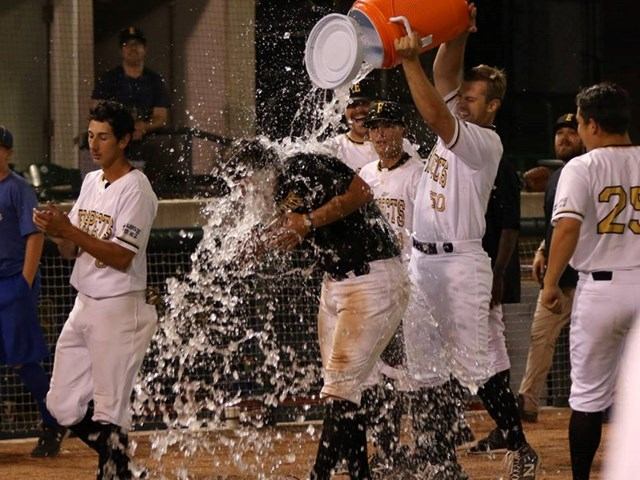 Players celebrate with a victory splash on the field.