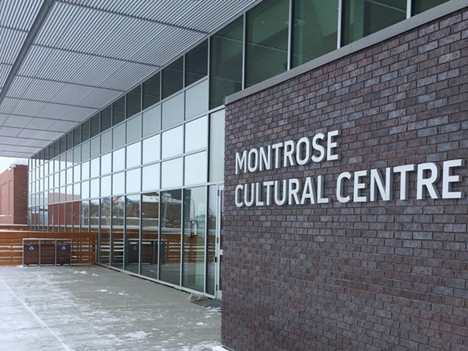 Montrose Cultural Centre brick building with signage and glass wall windows outside.