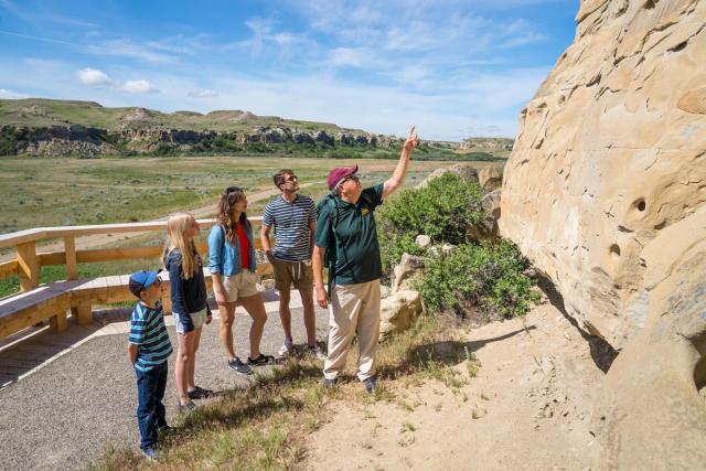 A family on a guided tour at Writing-on-Stone Provincial Park in Southern Alberta.