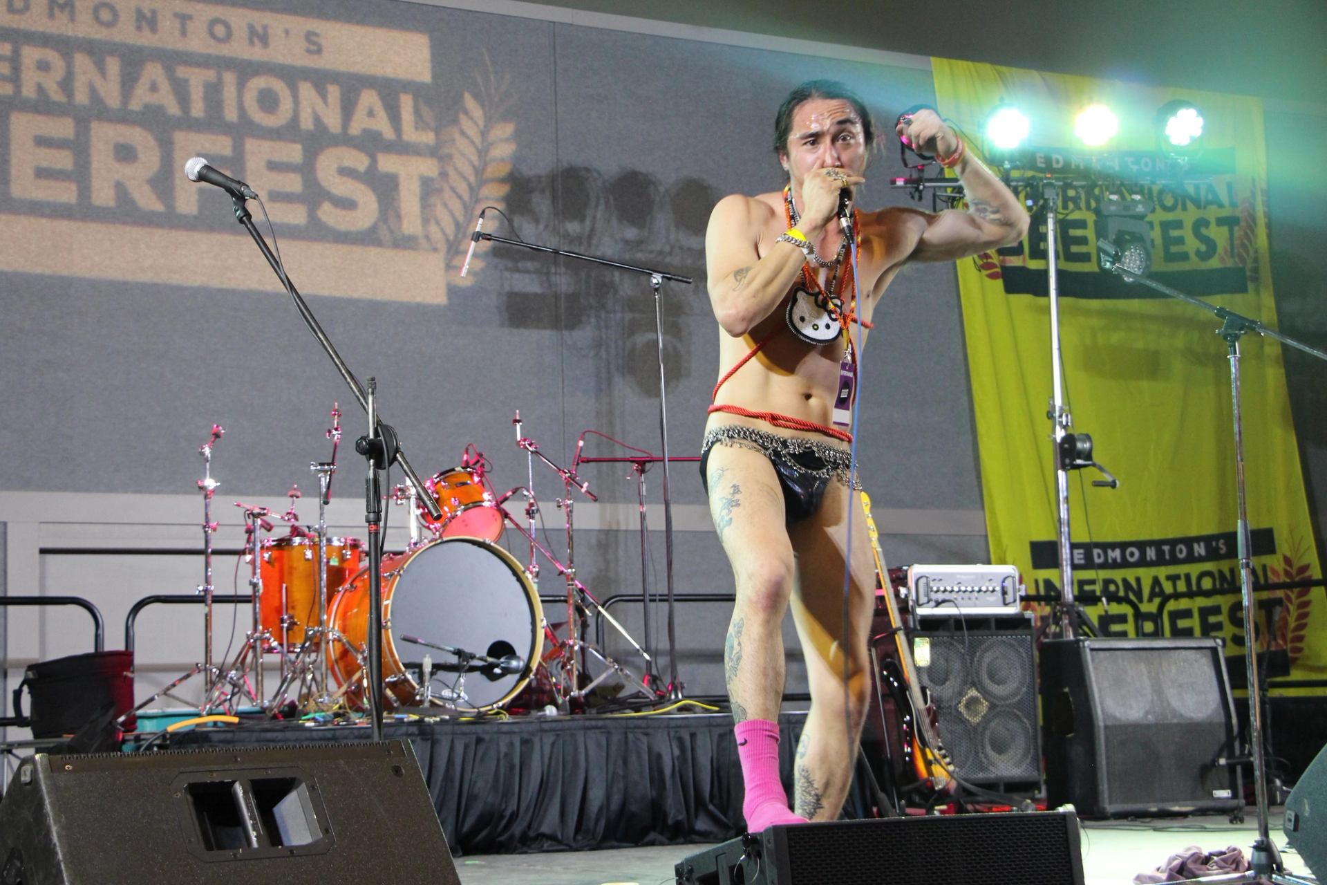Solo performer in bold costume posing on stage at Edmonton’s International Beerfest.