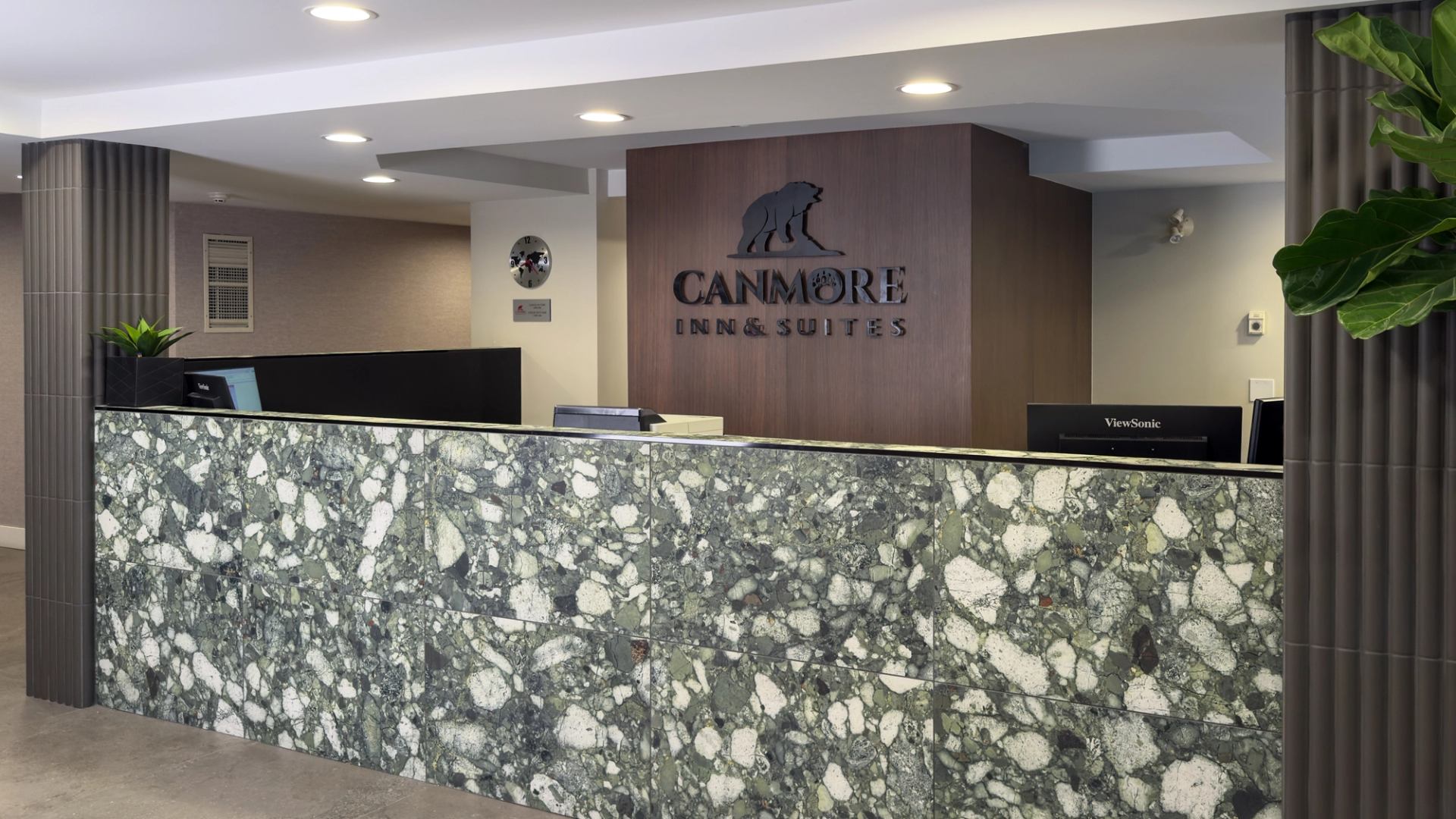 Renovated front desk at Canmore Inn & Suites featuring a modern look counter and contemporary decor.