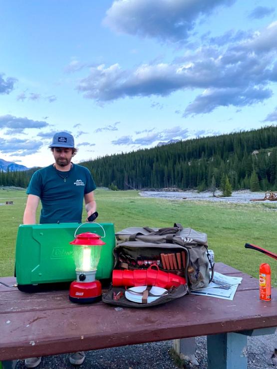 Person setting up campsite with Banff Camping Rentals.