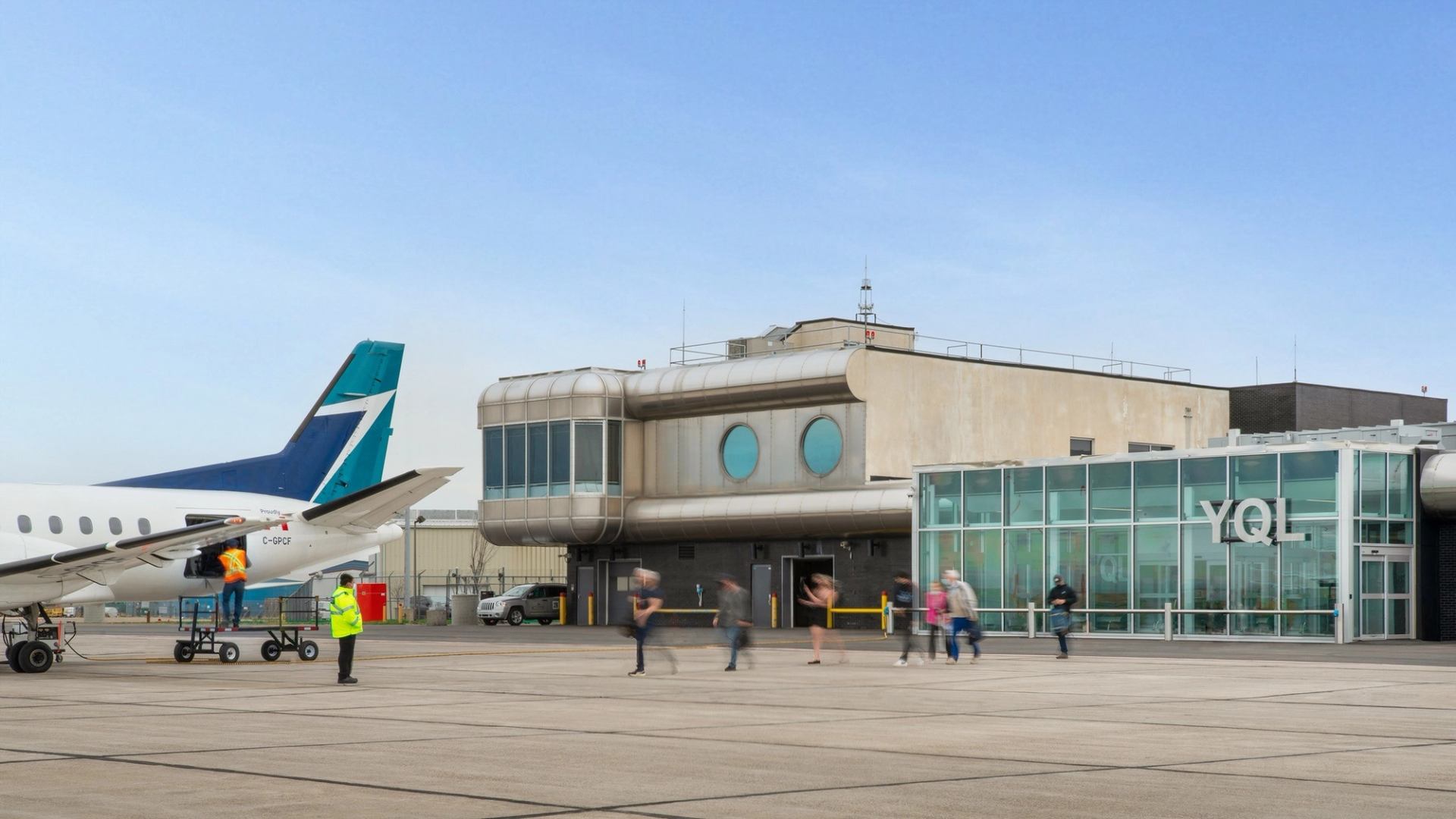 Small plane and terminal at Lethbridge County Airport with people nearby.