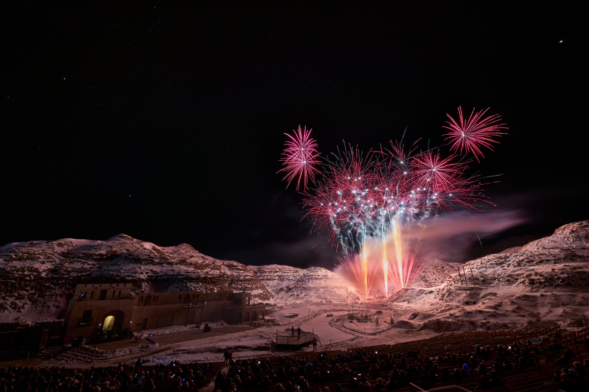 Pink fireworks explode above the hills of the Badlands Amphitheatre