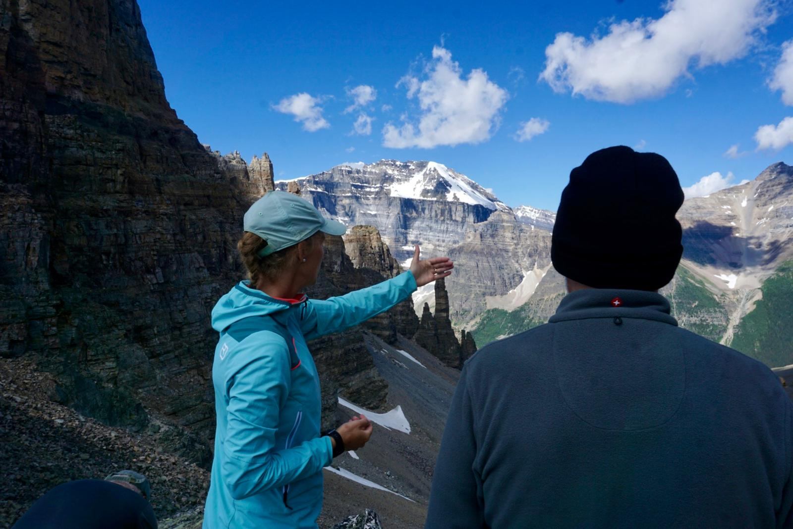 one guest and one guide on a pass over the mountains, the guide is sharing local knowledge.