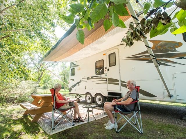 A couple sat outside their RV