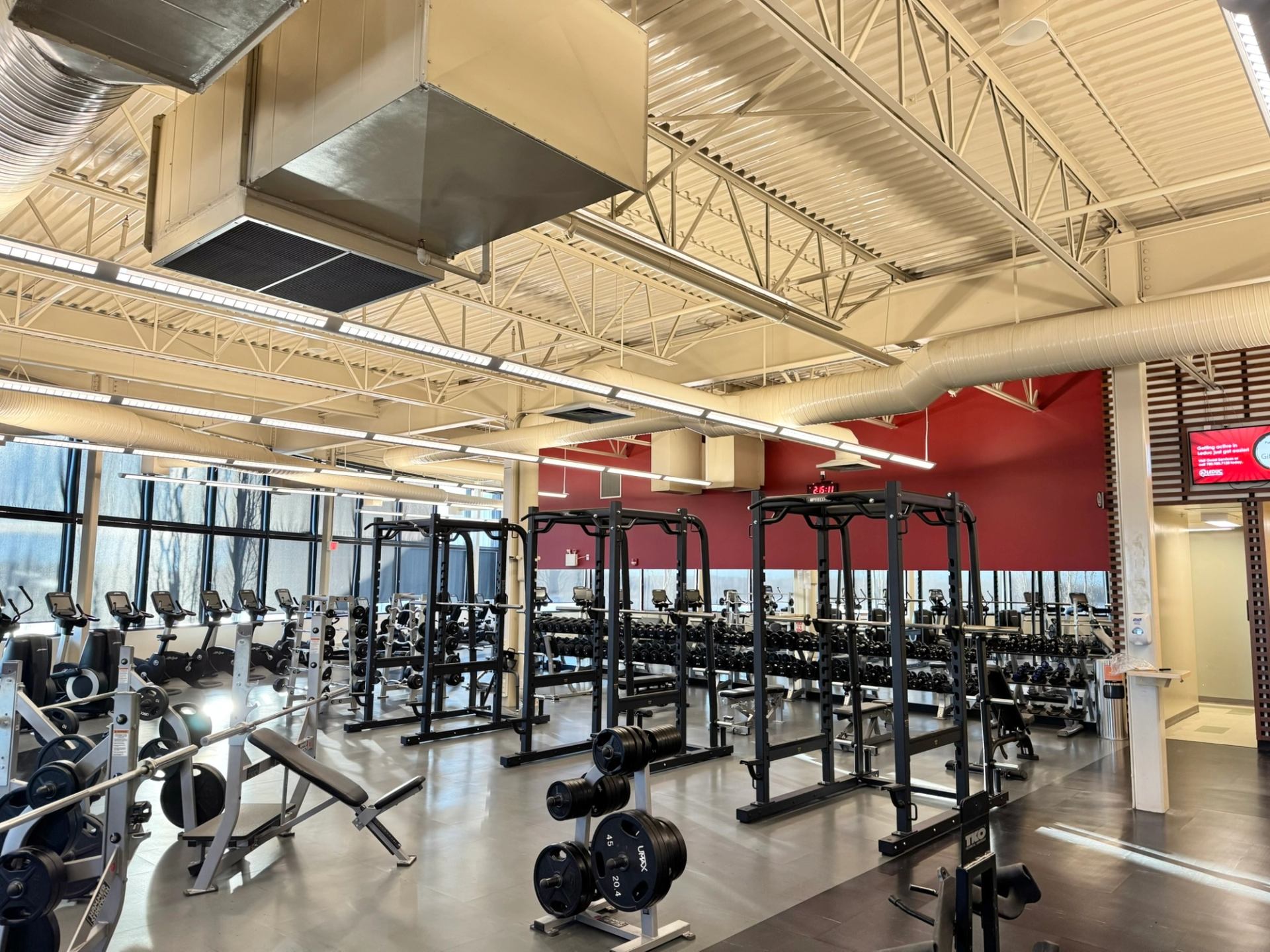 Spacious gym at Leduc Recreation Centre with cardio and weight training equipment.