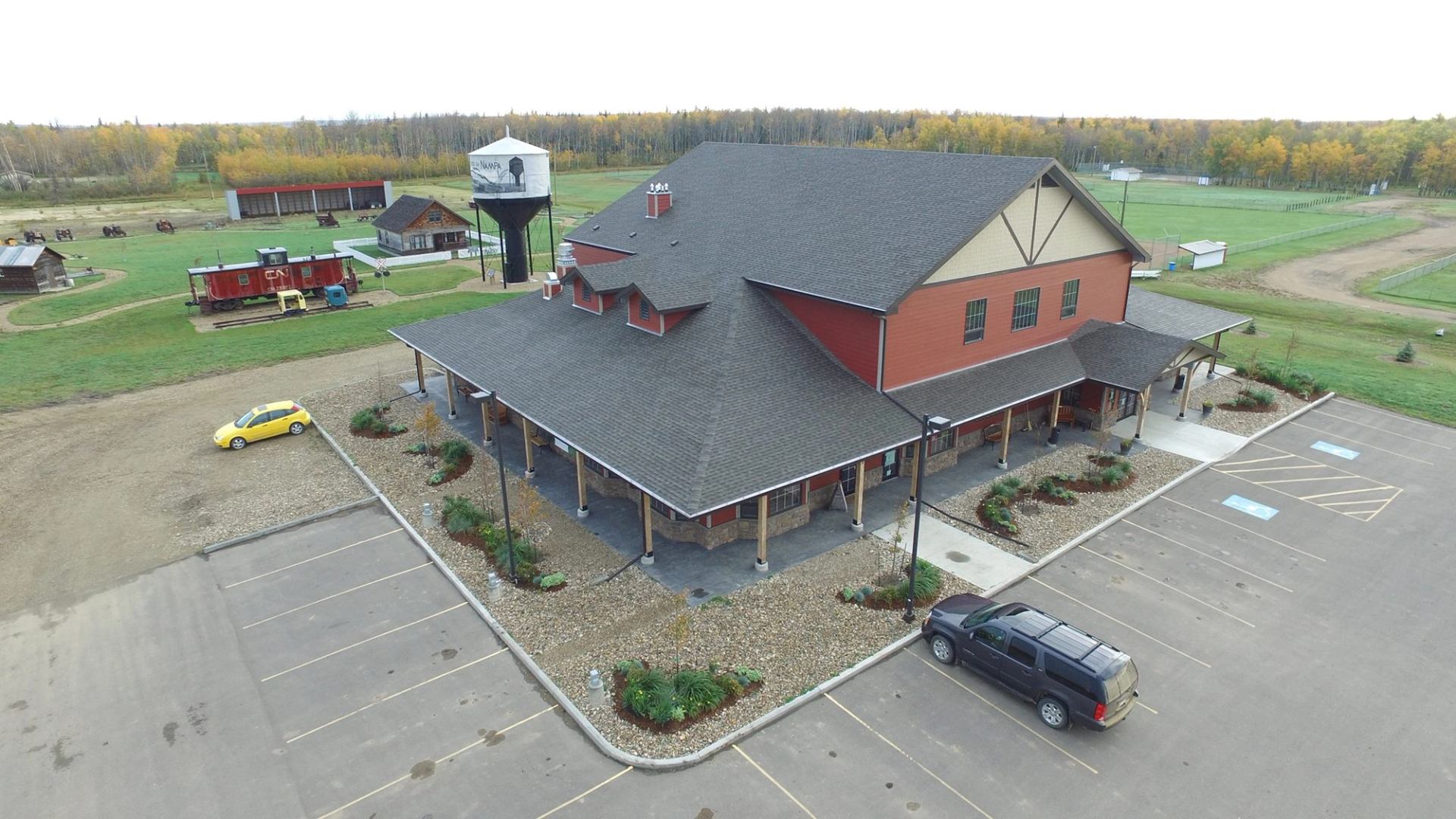 Front view of Nampa and District Museum building with parking lot and heritage displays.