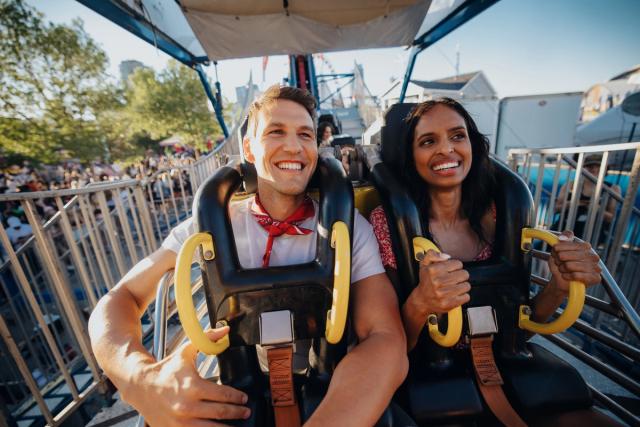 Couple enjoying a ride at the midway during the Calgary Stampede.