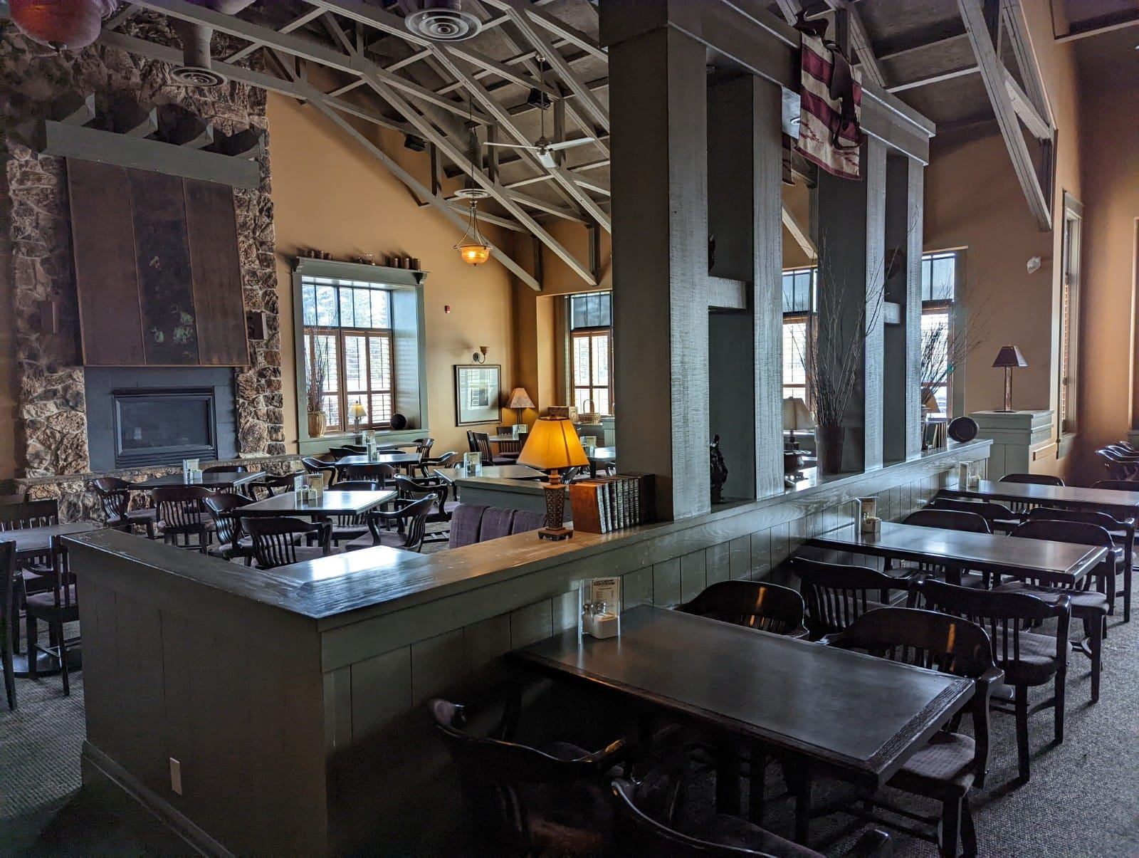 Restaurant interior with fireplace, tables, and warm lighting.