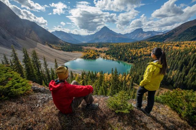 Couple looking out at mountain view while hiking in Peter Lougheed Provincial Park.