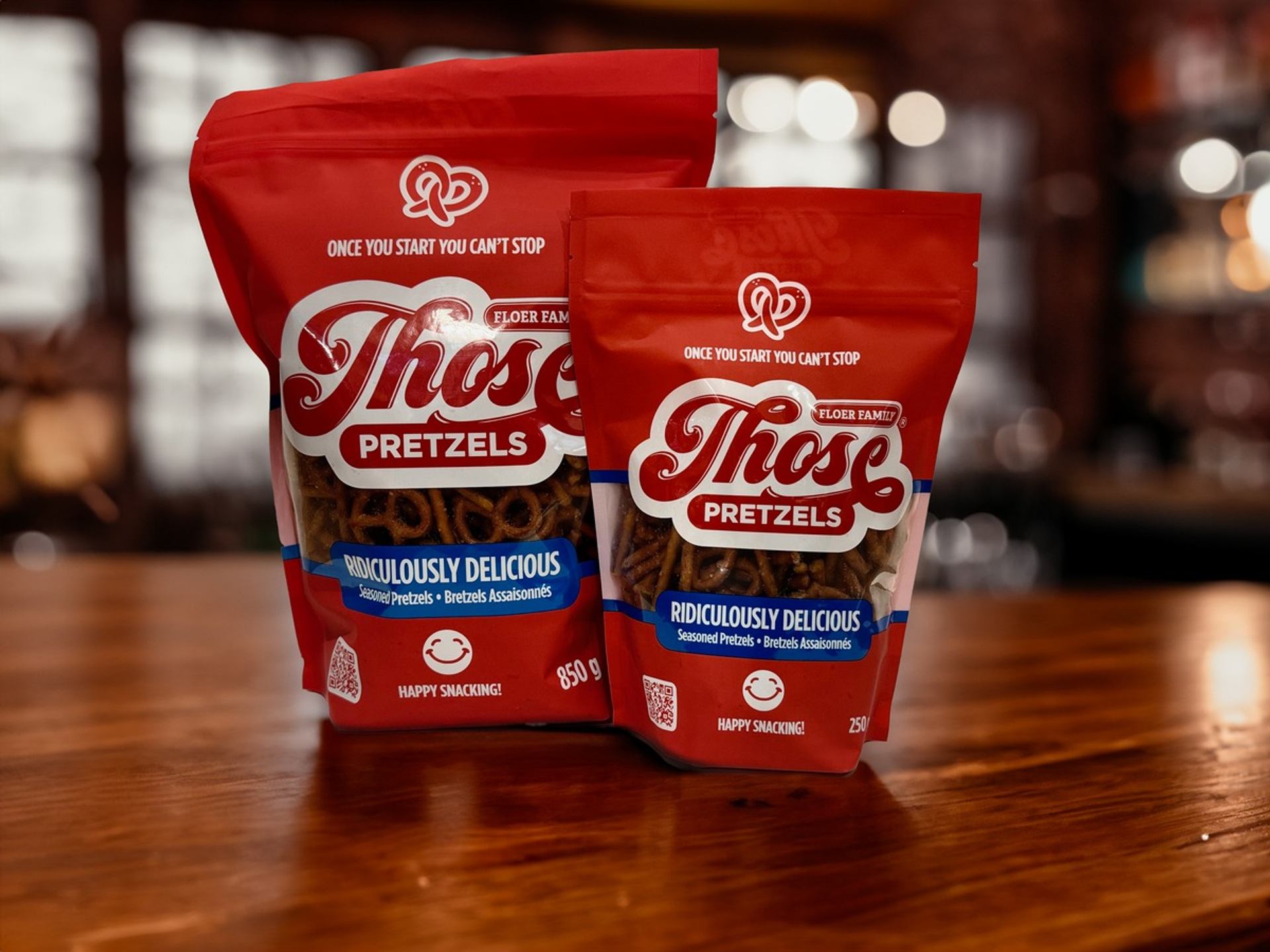  Two red bags of Those Pretzels on wood, labeled “Ridiculously Delicious” and “Soft Pretzels.”