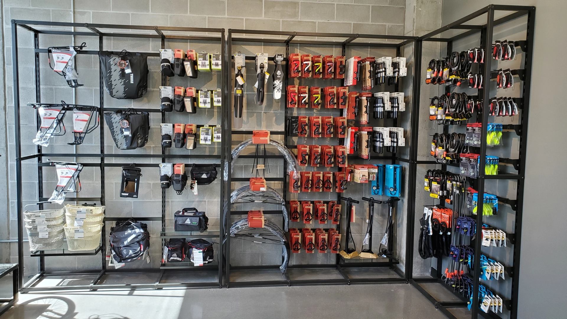 Bike accessories neatly displayed on shelves in a retail store.