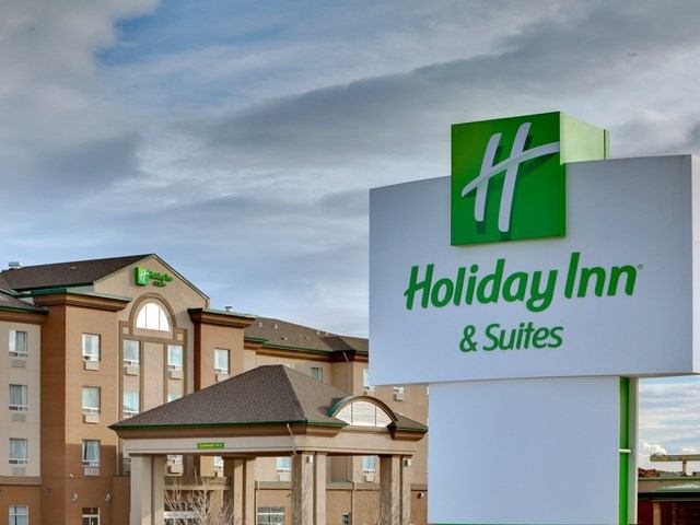 Exterior of Holiday Inn Grande Prairie with logo sign and beige multi-story building.