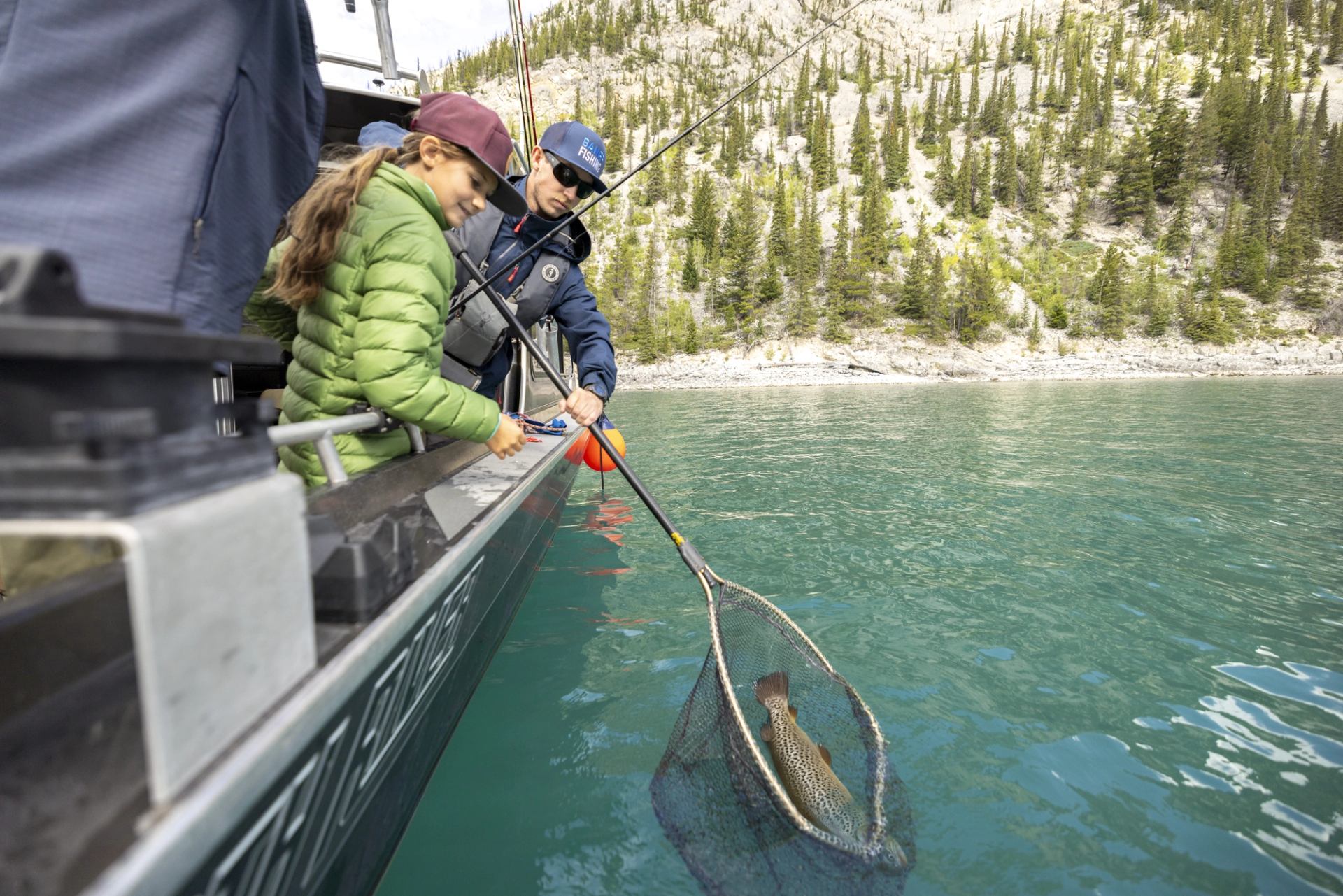 Using the net to catch the fish on a Banff Fishing Tour