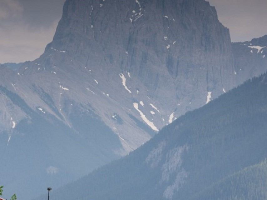 Mountain valley with glaciers and snow patches in the Canadian Rockies backdrop.