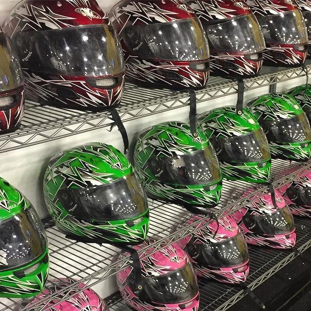 Colorful helmets on display at SPEEDERS Indoor Prokarts.