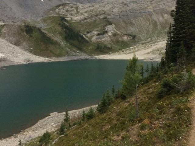 Alpine lake surrounded by rocky slopes and evergreens along the Galatea Lakes Trail.