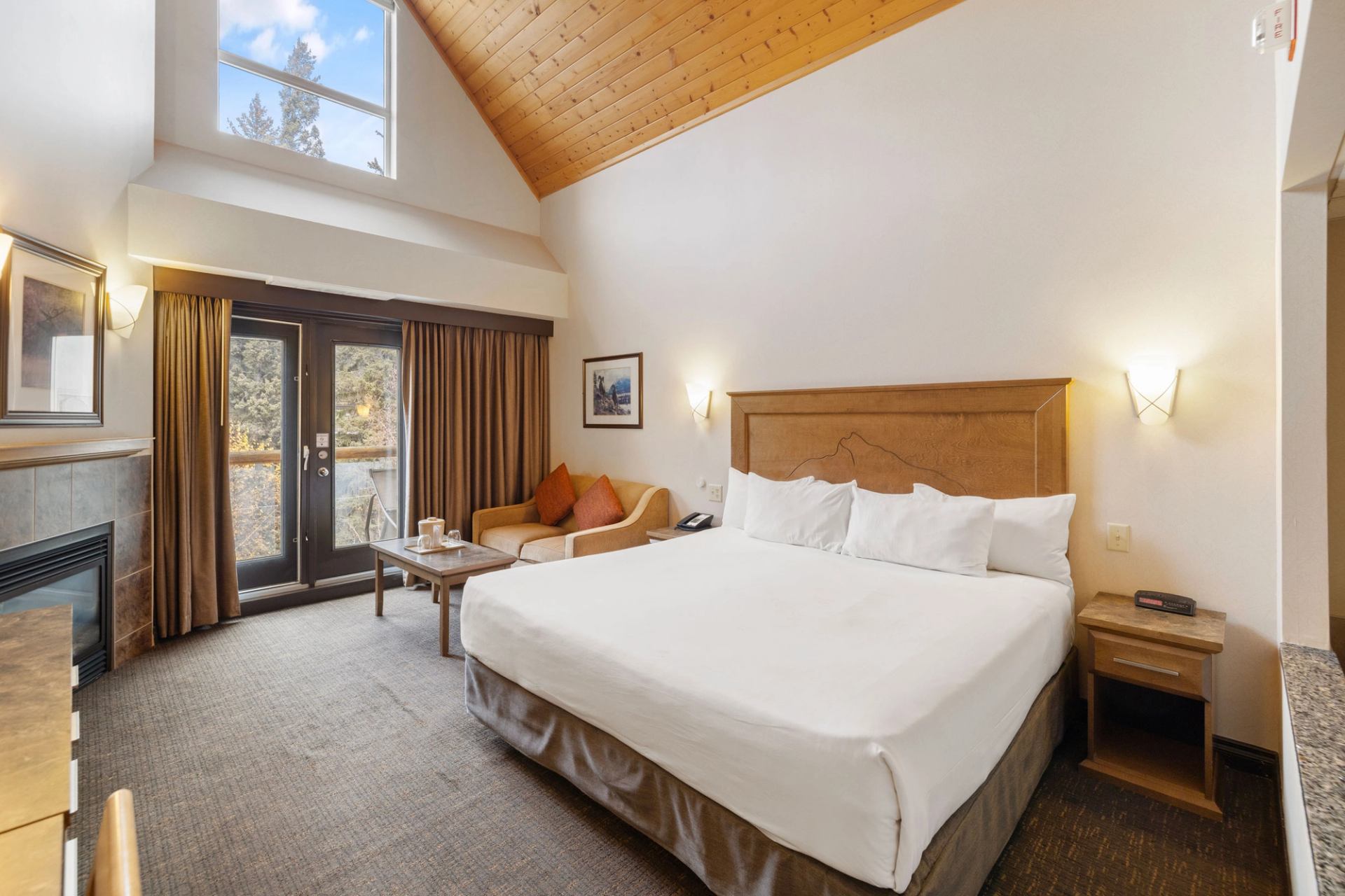 Comfortable lodge room with bed, seating area, and window view.