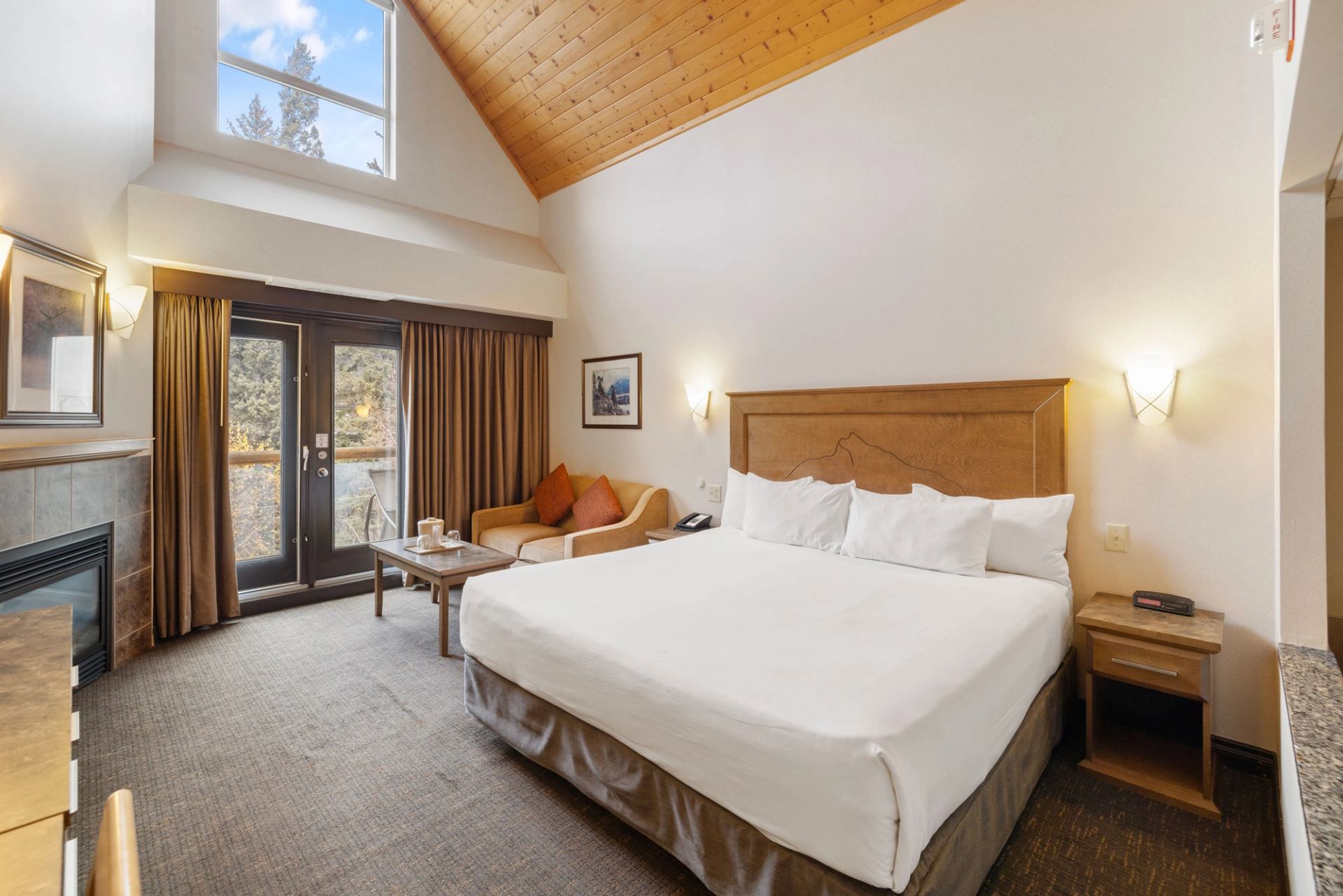 Comfortable lodge room with bed, seating area, and window view.
