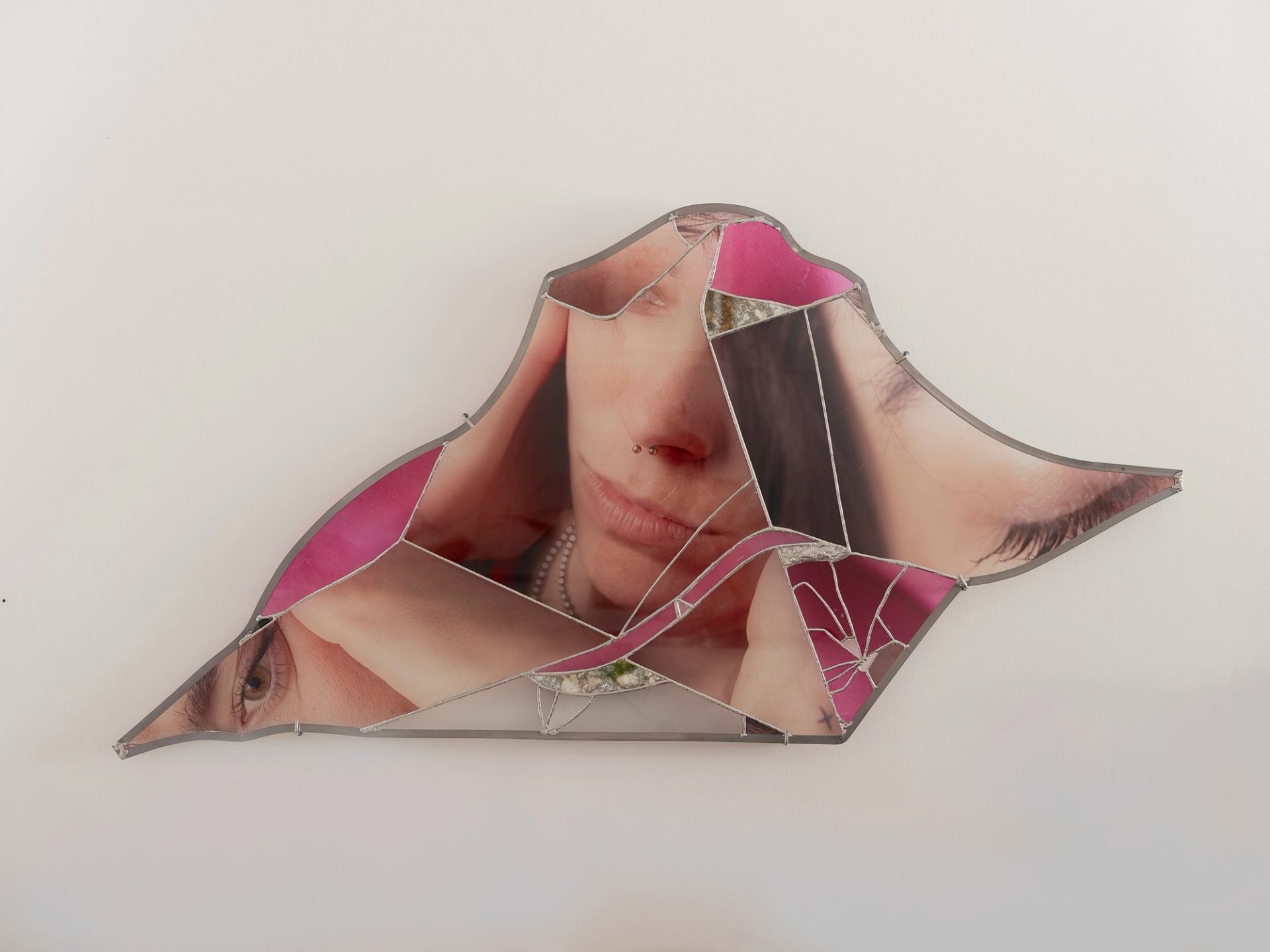 Abstract collage of fragmented facial features in geometric form by Barbara Spohr.