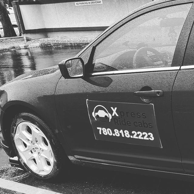 Black Xpress Ride Cabs car with phone number 780.818.2223 on the door.