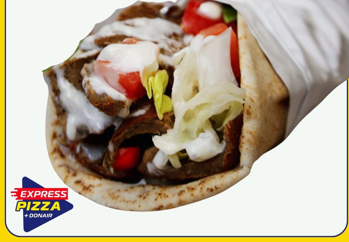 Authentic beef donair with fresh tomatoes, onions, and sweet sauce in a warm pita wrap.