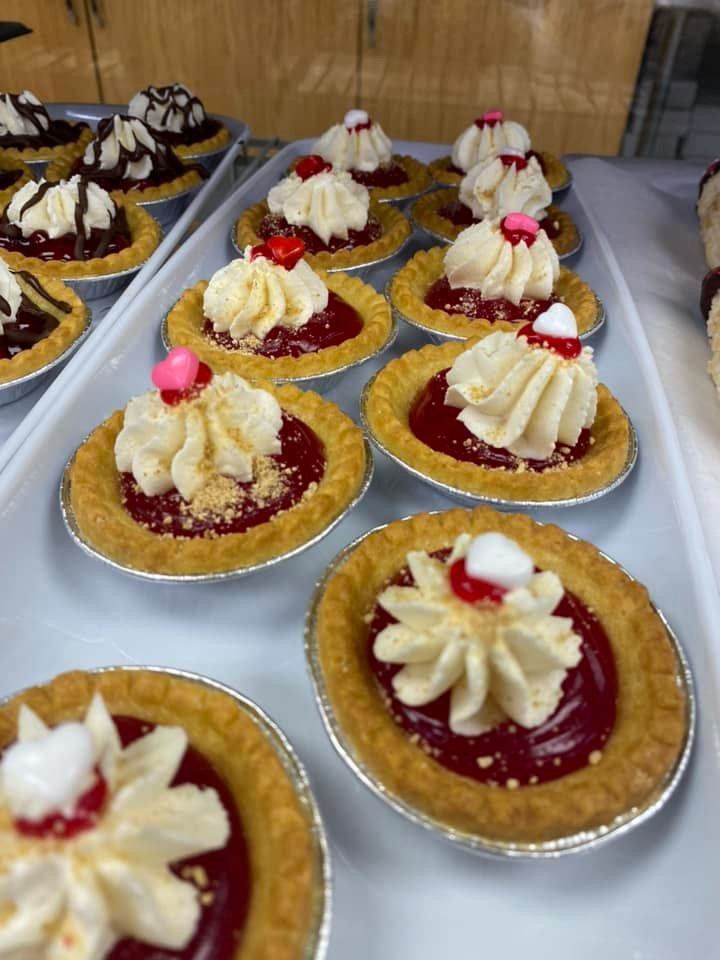 Mini tarts filled with red fruit topping and cream at Lakeview Bakery & Deli.