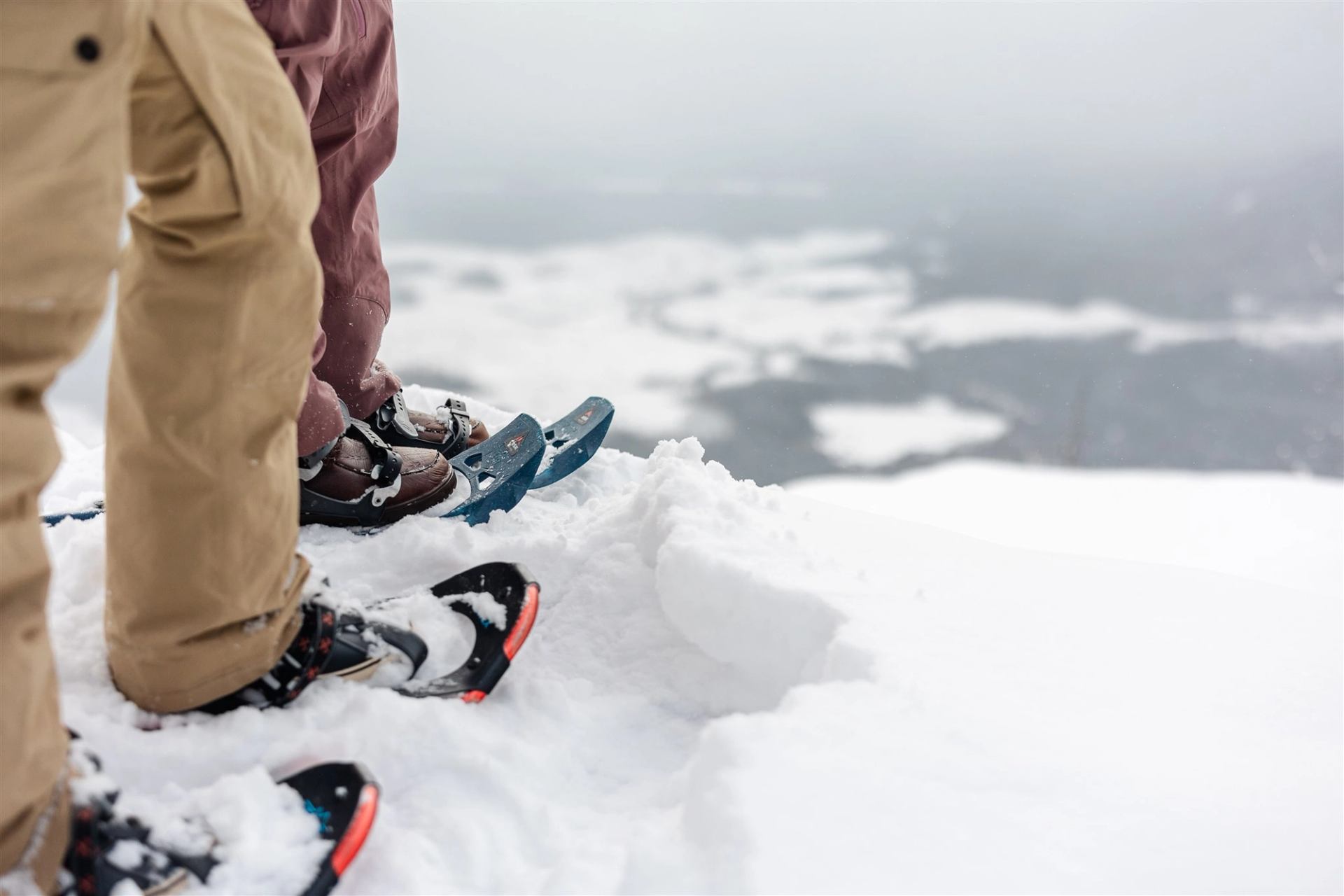 Close-up of snowshoes on a snowy cliff overlooking a frozen valley at Athabasca Lookout.