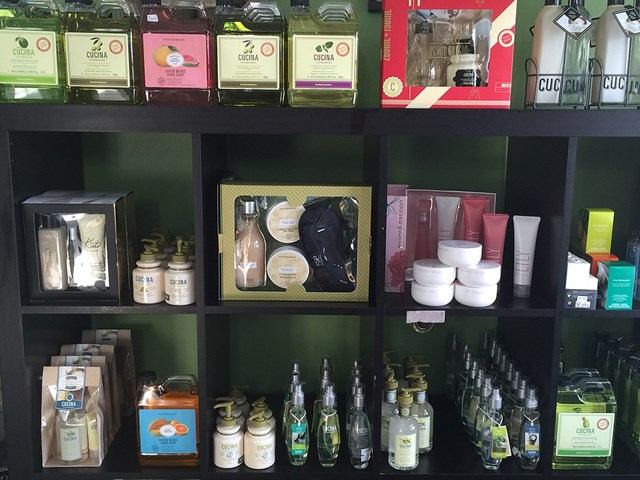 Store shelf with boxed items, bottles, and small jars in a display window.