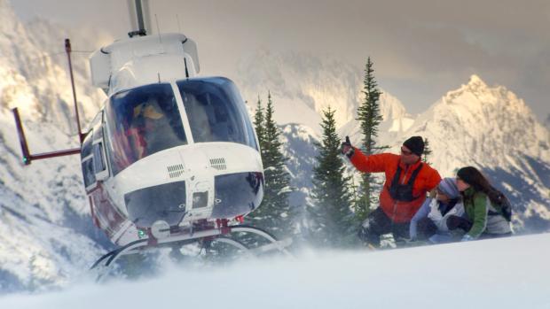 People being dropped off on a mountain for Heli snowshoeing