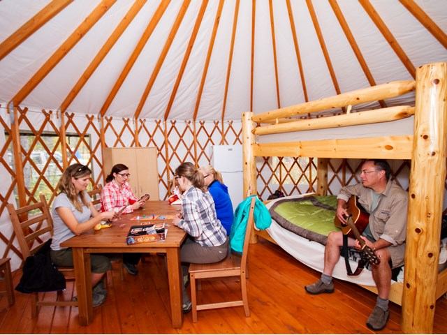 People inside the yurt sitting around a table